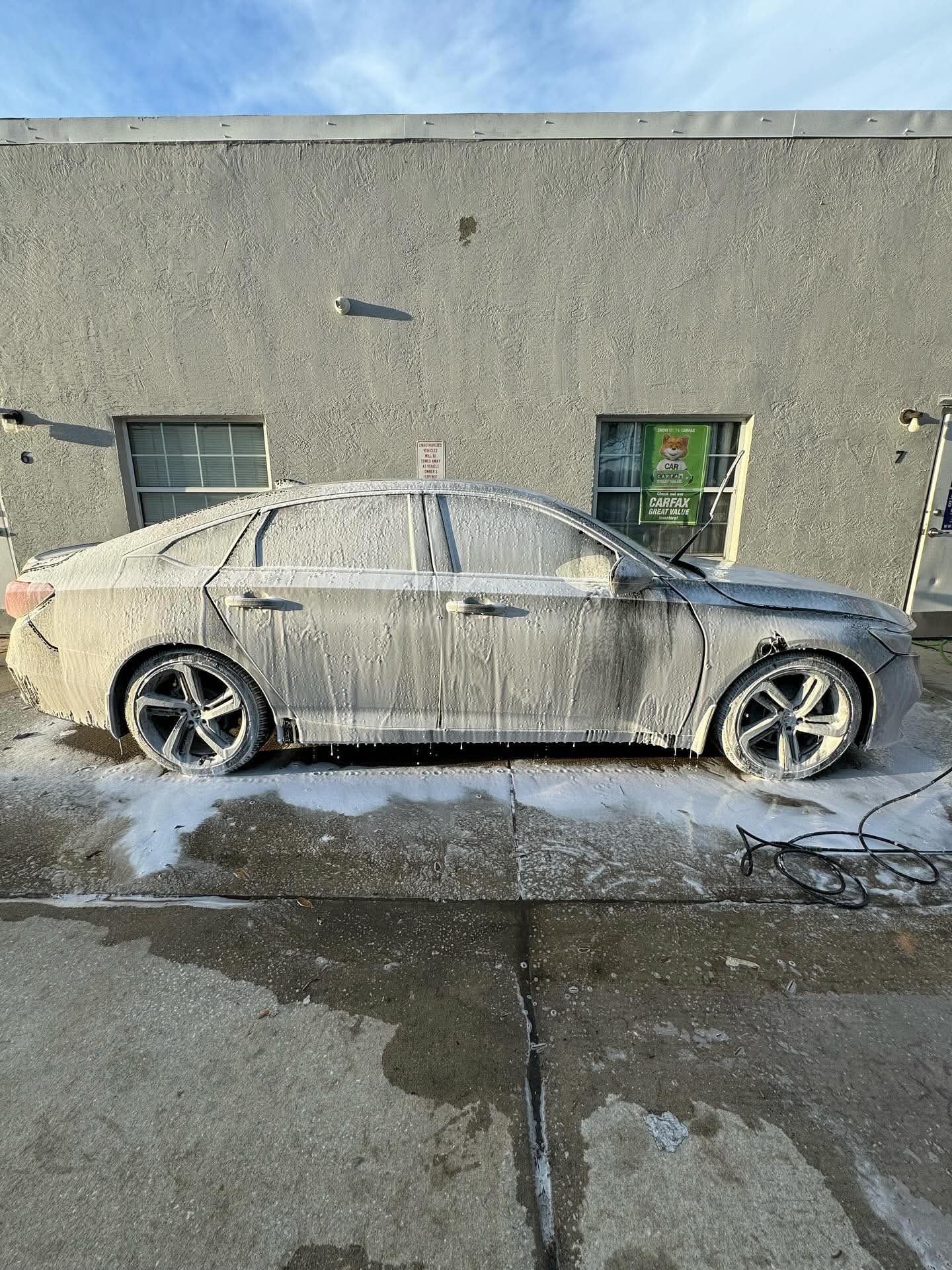 Honda Accord covered in snow foam during a hand wash